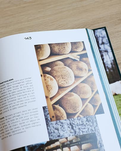 Bernard Antony’s book Fromage open at a page with photos of cheeses being ripened